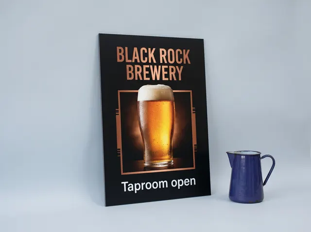 A black Black Rock Brewery aluminium sign showing a golden pint