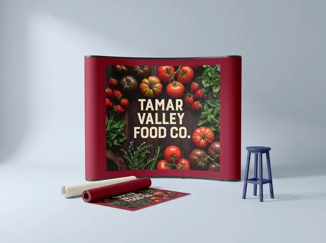 A Tamar Valley Food Co. pop-up stand in new crimson panels, with spare panels rolled in front