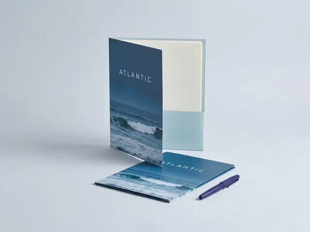 Matt black Atlantic presentation folders with a gloss wave pattern, one open to show its pocket
