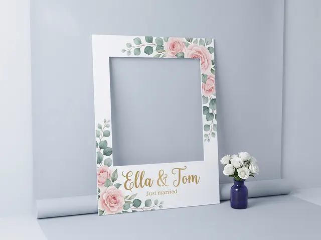 An Ella & Tom wedding selfie frame with watercolour roses around the cut-out