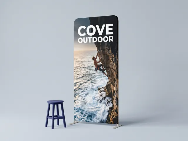 A curved Cove Outdoor fabric wall showing a climber on a sea cliff